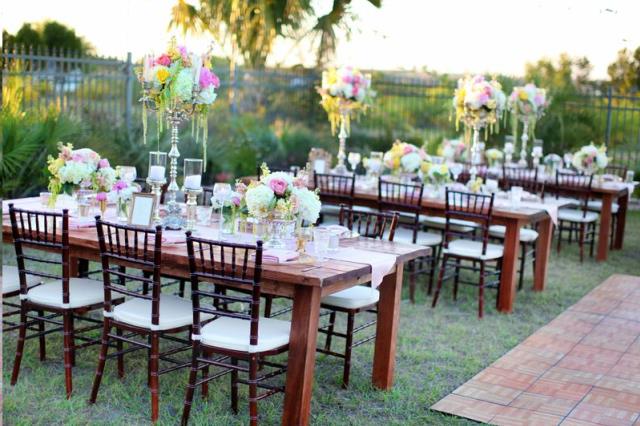 Mahogany Chiavari chairs with ivory cushions set at farm tables for an outdoor wedding reception in Atlanta, Georgia