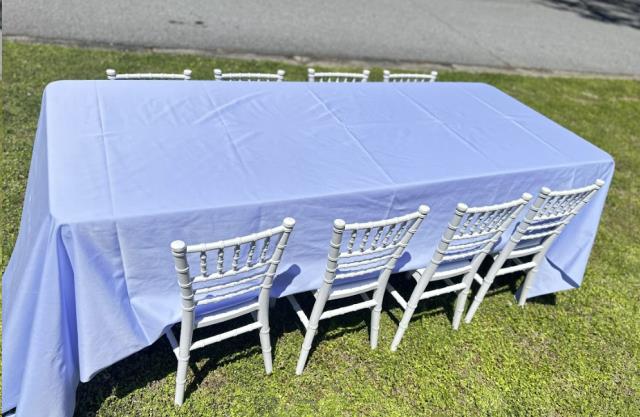 Kids party table with white linen and white chiavari chairs set up outdoors in Atlanta, Georgia